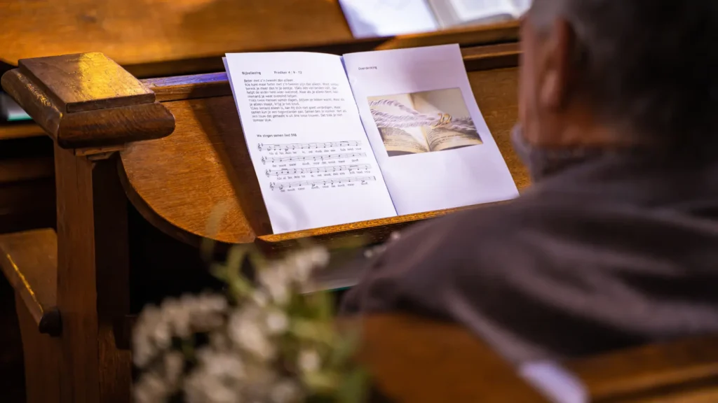 Man Reading Catholic funeral songs and hymns